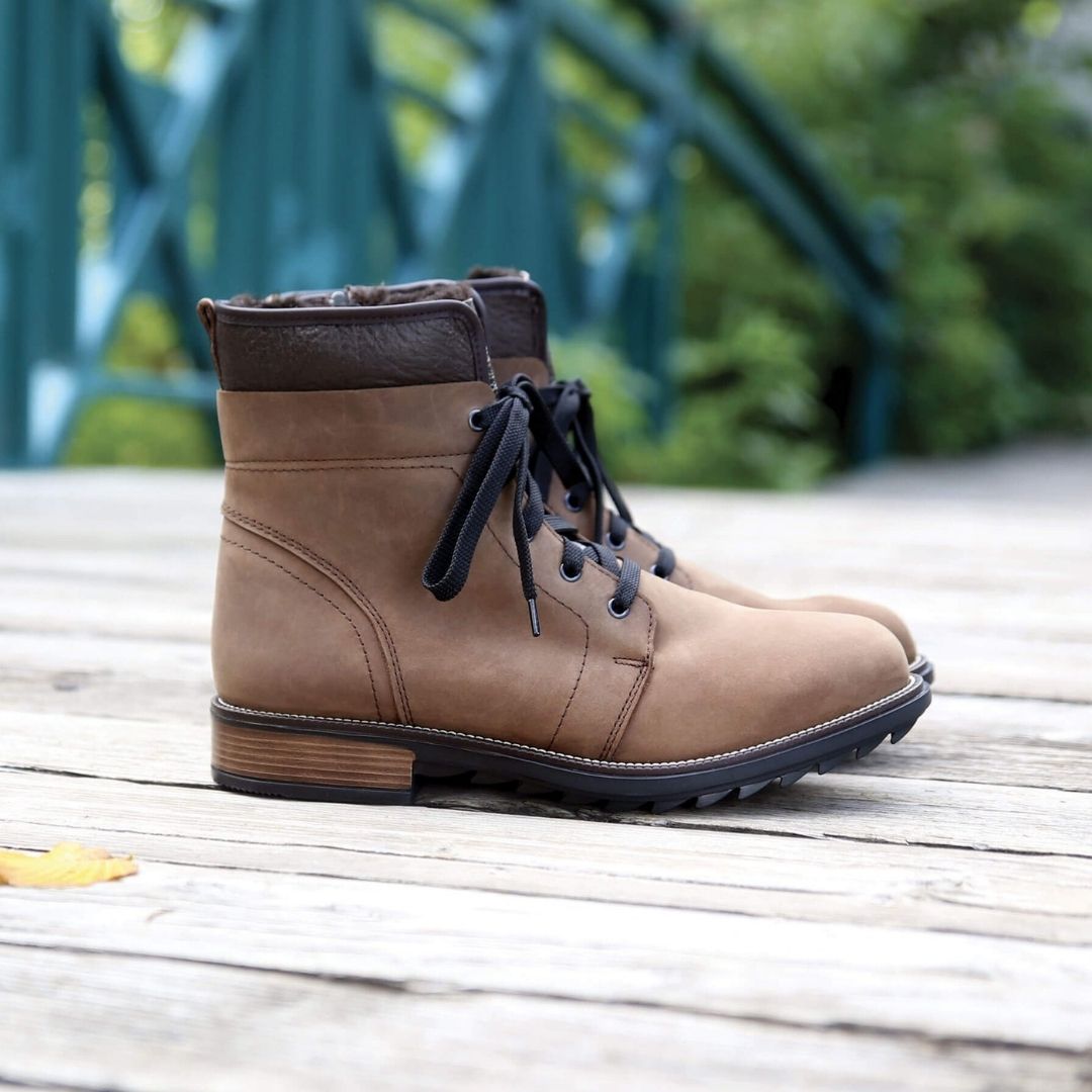 Brown nubuck leather combat styled boot with black laces and a stacked heel.