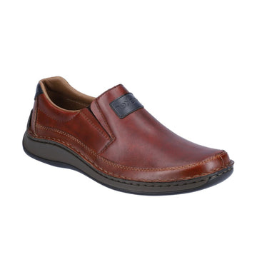 Brown leather slip on shoe with navy Rieker logo tag on instep.