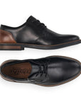 Top and side view of black leather dress shoe with brown heel counter and zipper closure. Rieker logo on insole.