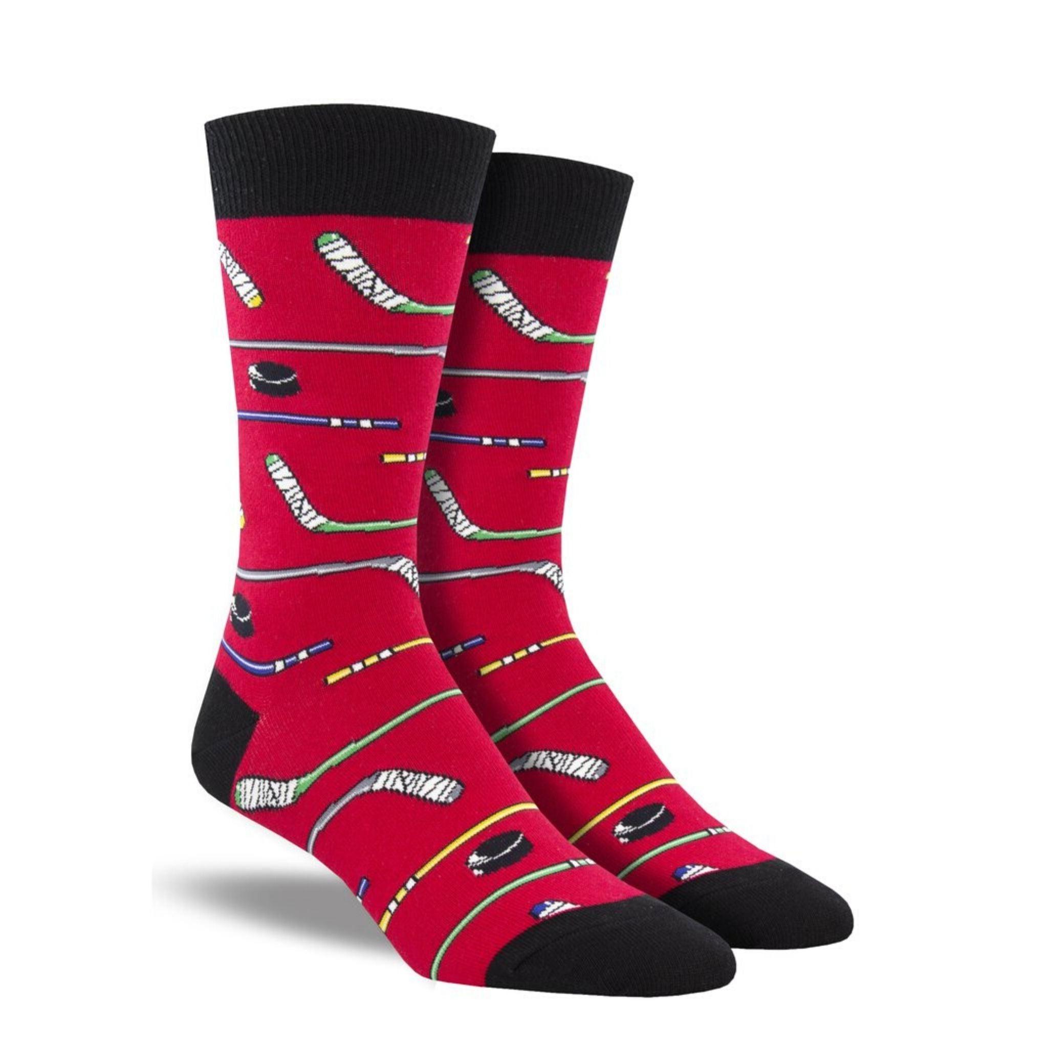 A pair of red crew socks with hockey sticks on them.