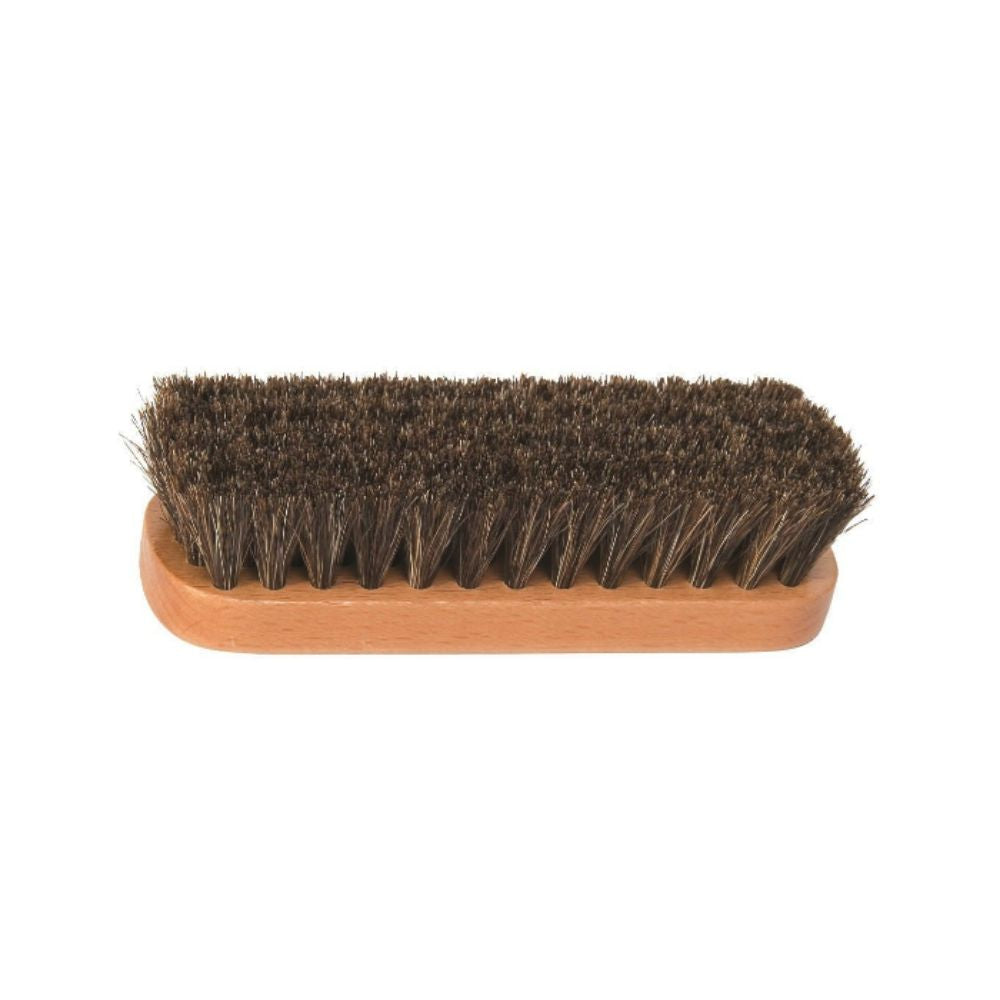 Flat wooden handle with course brown bristles on shine brush