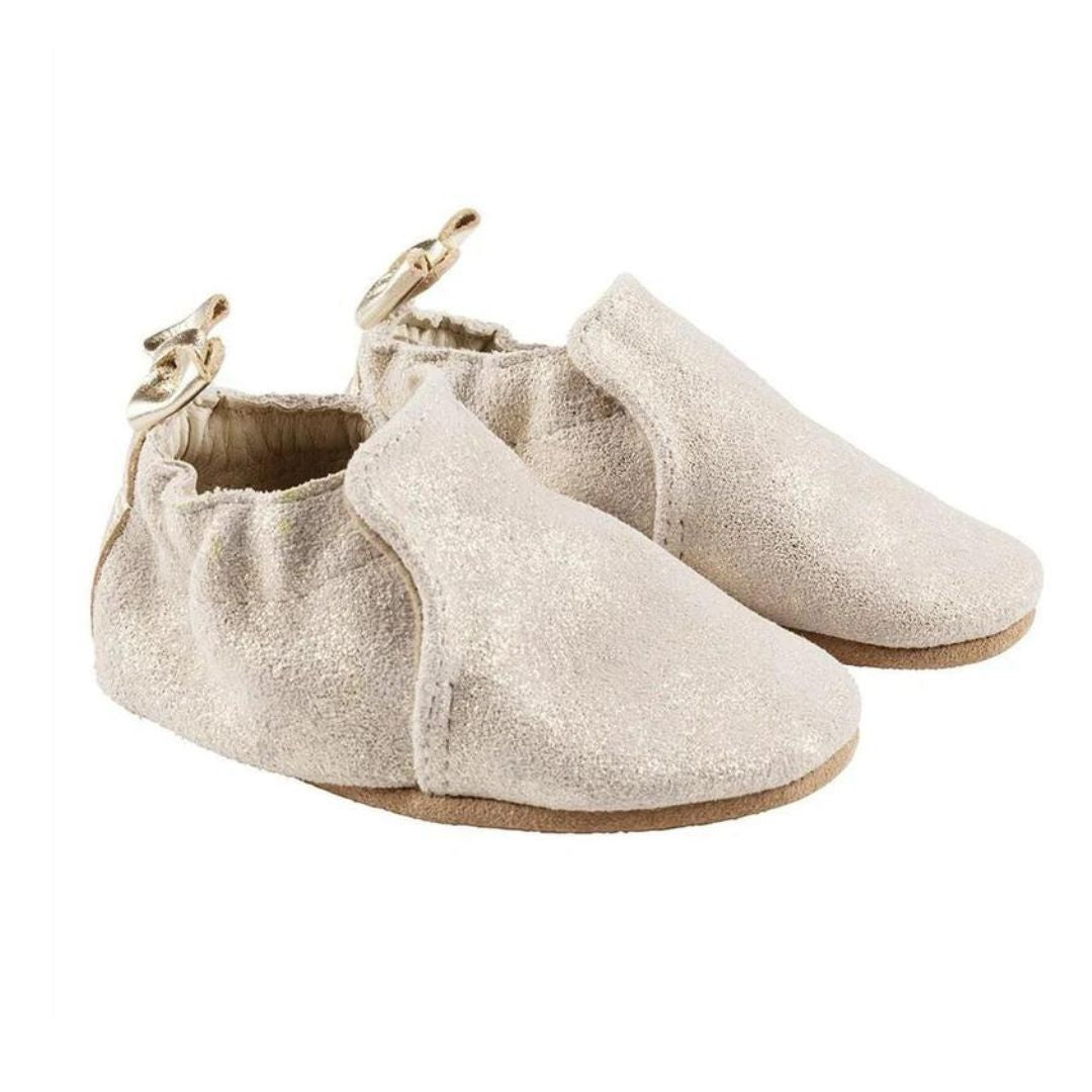 Gold glittery baby shoes with brown outsoles and stars on the heels.