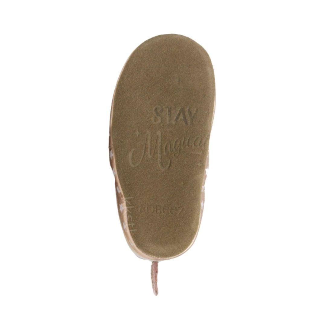 Brown suede leather outsole of Robeez Evie unicorn shoes with imprint saying &#39;stay magical&#39;