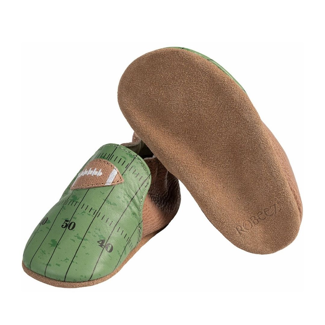 Front and bottom view of Robeez Soft Sole shoe with brown back and green toe featuring football field and football