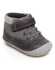 Grey leather ankle boot with Velcro strap and light grey outsole.