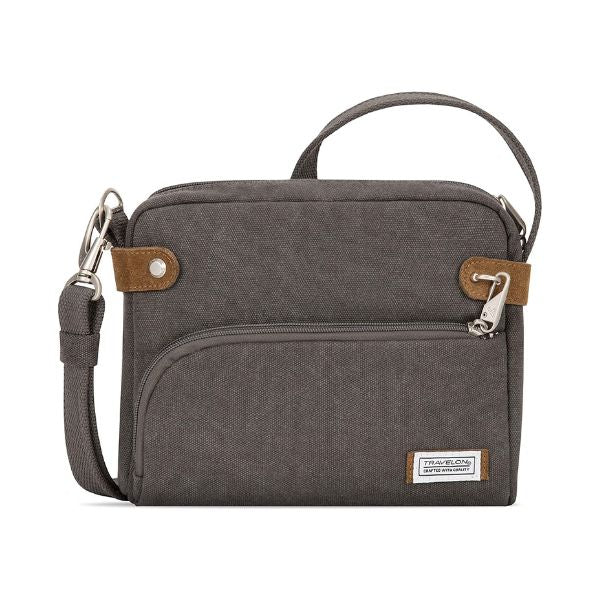 Grey canvas crossbody bag with top and front zipper. Patch on front with Travelon logo on it.