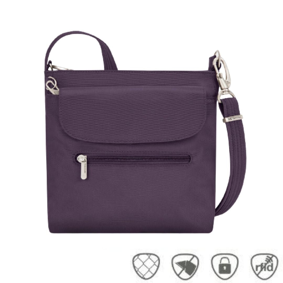 Purple crossbody bag with front flapped pocket and front horizontal zippered pocket. Bag has silver zippers and clasps