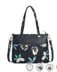 Black tote style bag with floral print. Bag has removable crossbody strap.