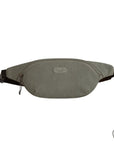 Grey fanny pack with zippered closure and Travelon emblem on front.