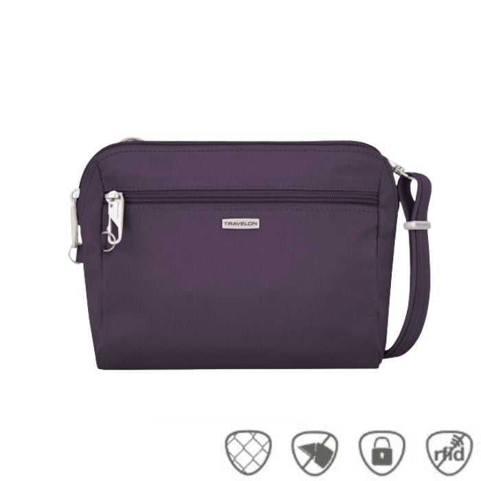 Small purple crossbody bag with silver Travelon logo in center below full length zipper.