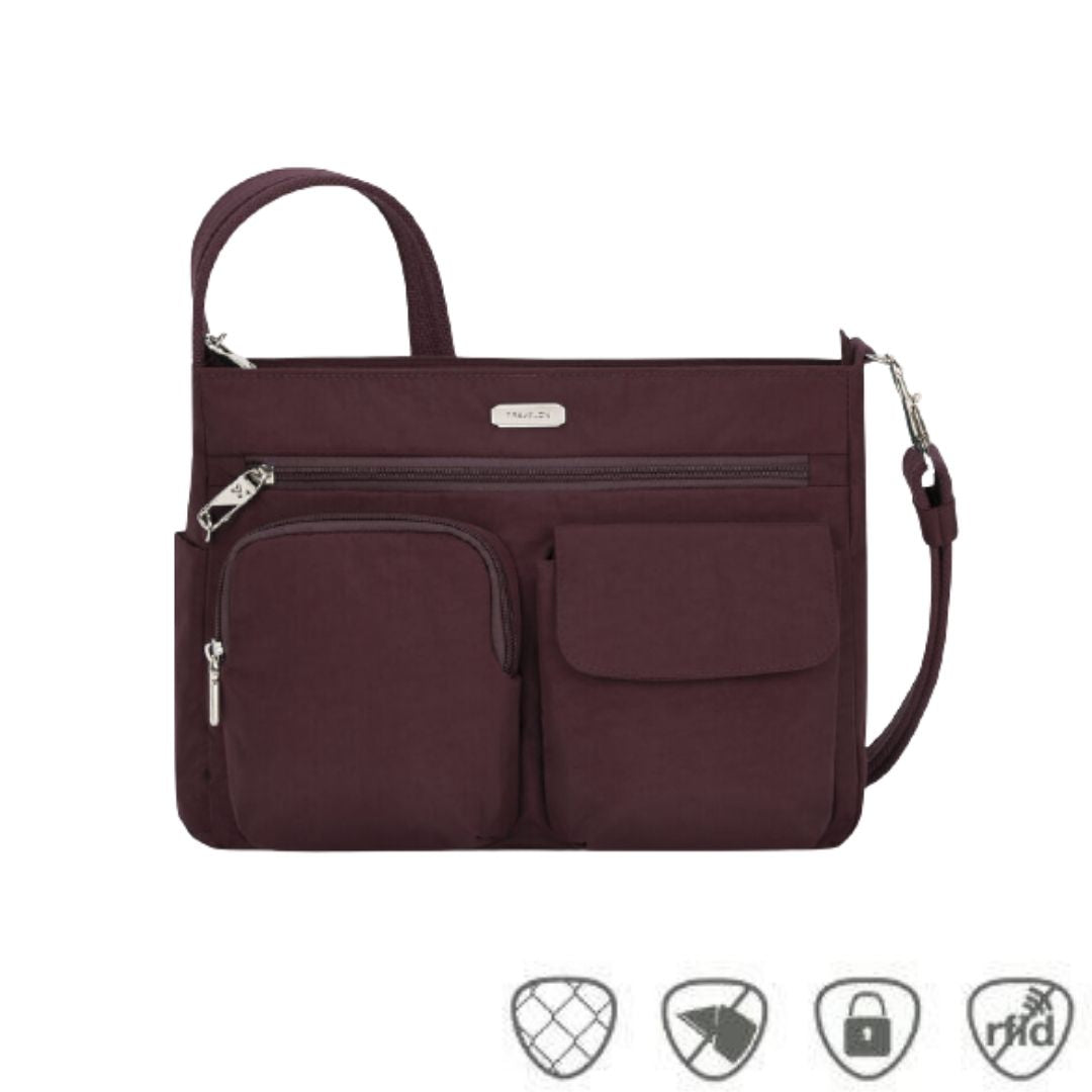 Burgundy crossbody bag with front zippered pouch, flap pocket and full length zippered pocket.