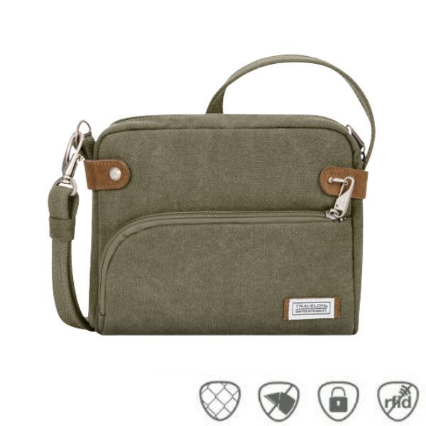 Olive green canvas crossbody bag with top and front zipper. Patch on front with Travelon logo on it.