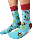 Socks from Uptown Sox showing Christmas trees and avocados people. Says, "Guacin' Around The Chritmas Tree."