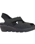 The Lihi Brighten by Bernie Mev has a black woven upper that are open toe and heel  with criss crossing straps and a thick black slight wedge heel