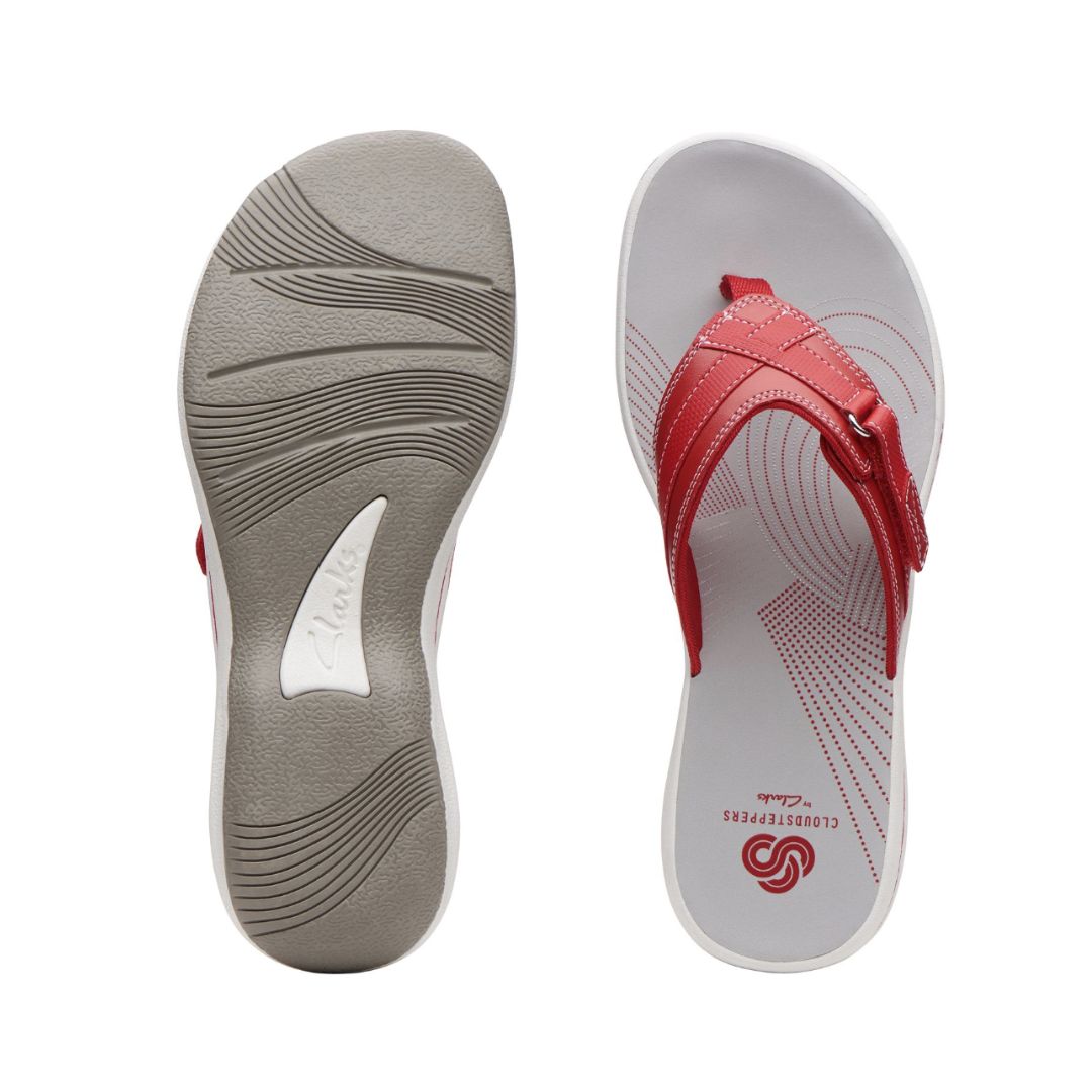 Top and side view of thong sandal with white and grey footbed and red upper with cute Velcro close detail. Clarks logo imprinted on insole at heel.