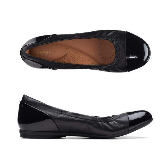 Black leather ballet flat with patent toe cap and heel. Clarks logo printed on brown insole.