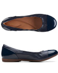 Navy leather ballet flat with patent toe cap and heel. Clarks logo printed on brown insole.