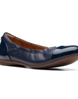 Navy leather ballet flat with patent toe cap and heel.