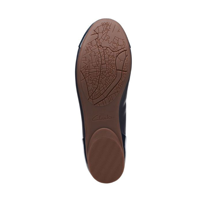Brown rubber outsole with Clarks logo in center.