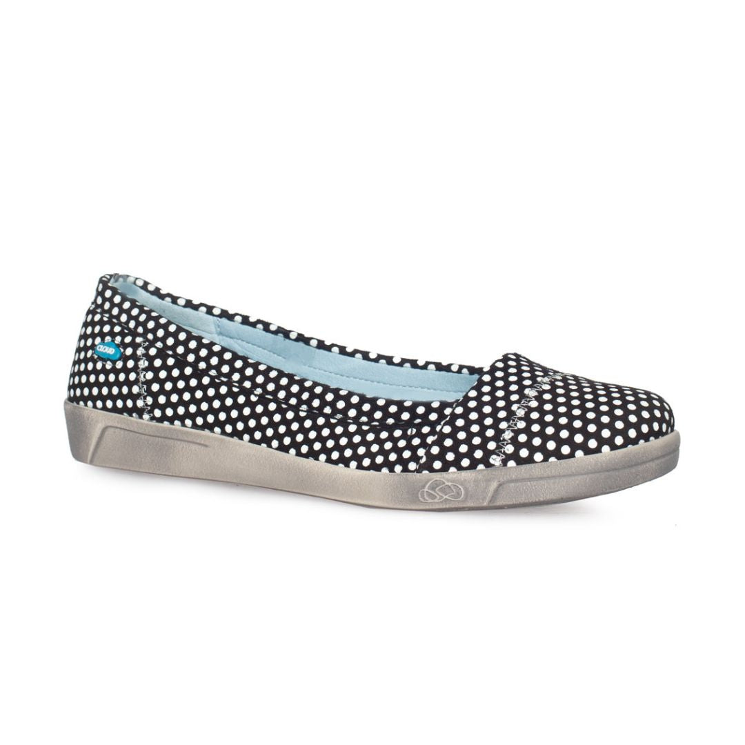 Black with white polka dots ballerina flat with beige outsole and blue Cloud footwear at heel.