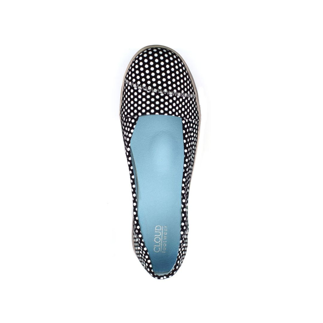 Top view of black and white polka dot ballerina flat with blue insole and Cloud Footwear logo on heel