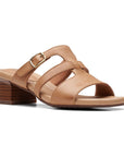 Tan leather slide sandal with gold buckle and brown stacked heel.
