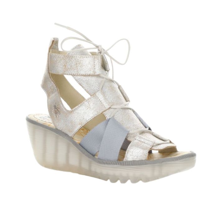 Silver lace up sandal with translucent wedge outsole.