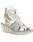 Silver lace up sandal with translucent wedge outsole.