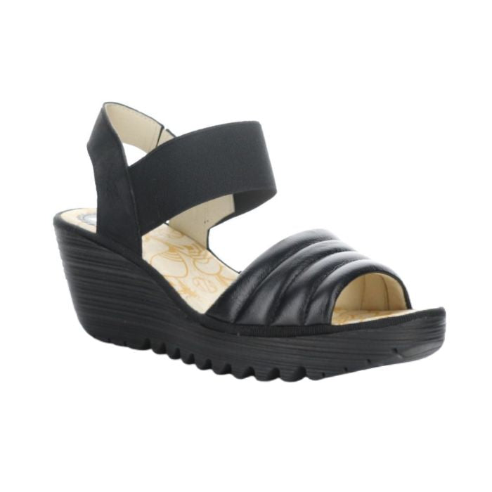 Black leather sandal on a platform wedge outsole.
