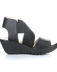 Side view of black leather platform wedge with adjustable ankle strap.