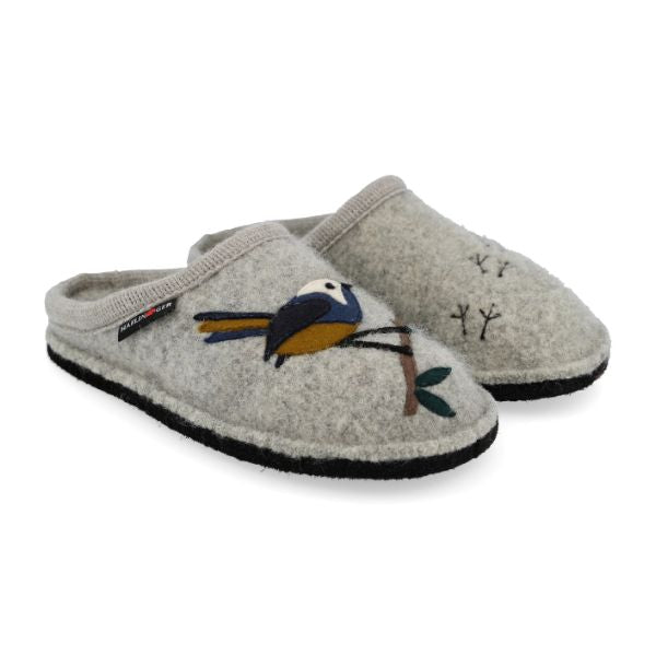 Grey wool slippers with a black outsole. One slipper has a blue and yellow bird on a twig, and the other has small bird footprints in black thread. 