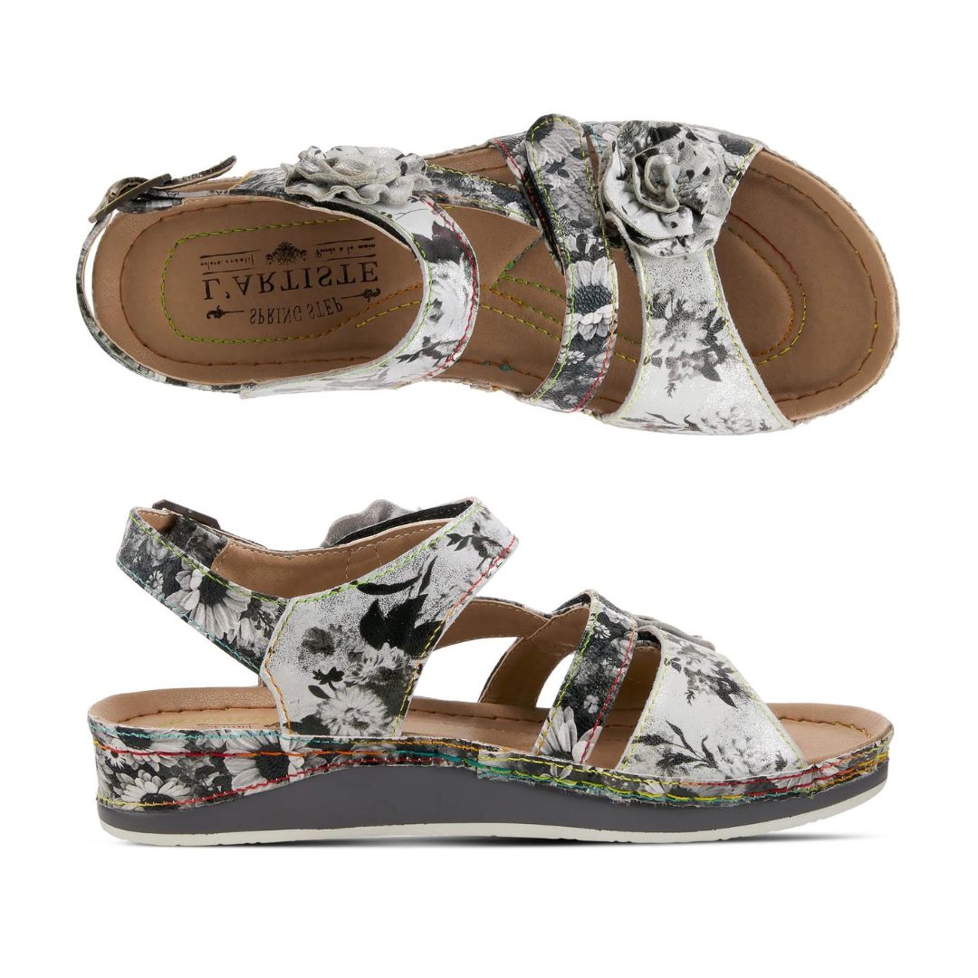 Top and side view of black and white backstrap sandal with floral details. L'Artiste logo is printed on insole.