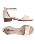 Off white sandal that has ankle strap with gold buckle and low stacked heel. Remonte logo printed on footbed.