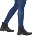 Legs wearing jeans and black leathre Chelsea boot with low heel.