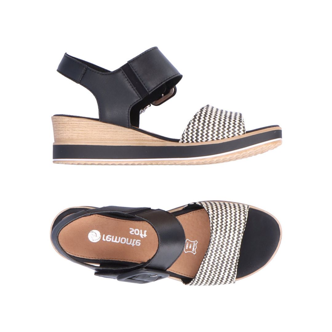 Black and white backstrap wedge sandal. Silver Remonte logo on brown footbed.