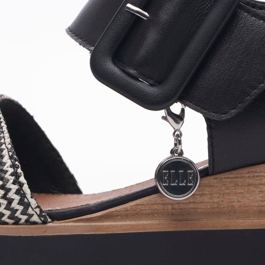 Black and white backstrap wedge sandal. Elle charm on sandal.