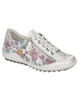 Silver floral lace up shoe with zipper side closure and grey midsole.