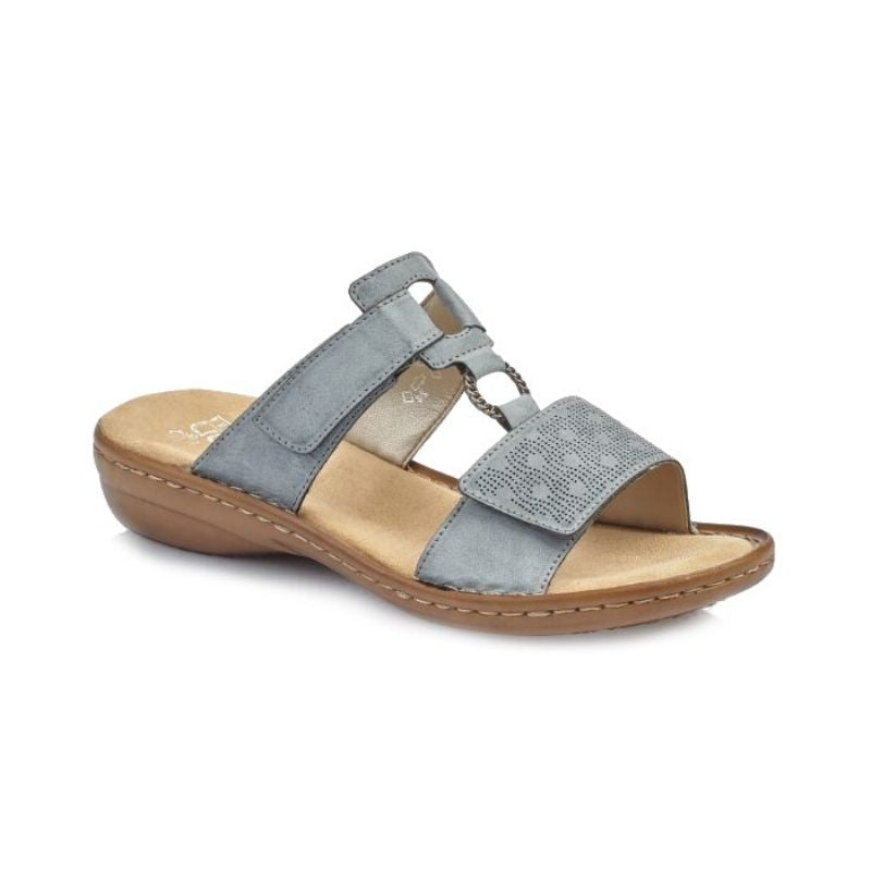 Blue slip on sandal with velcro straps and pinpoint design over toe strap with square and circle details and a tan footbed