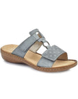 Blue slip on sandal with velcro straps and pinpoint design over toe strap with square and circle details and a tan footbed