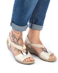 A pair of Light gold wedge sandal with silver circle detail