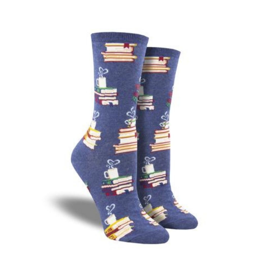 Blue  socks with stacks of books and coffee mug at top