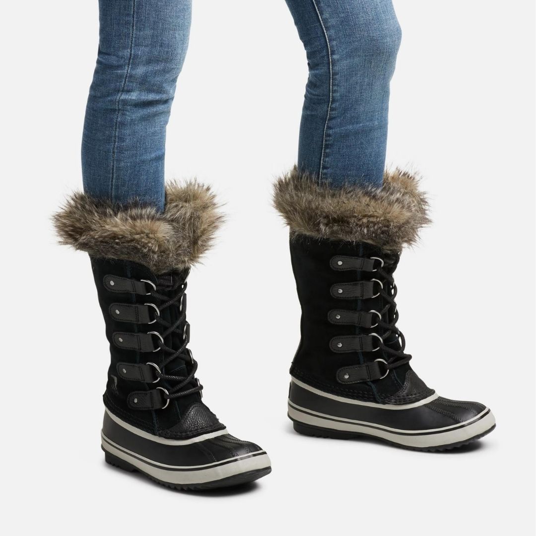 Pair of tall leather winter Sorel lace up boot with rubber foot and faux fur trim.