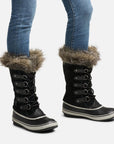 Pair of tall leather winter Sorel lace up boot with rubber foot and faux fur trim.