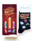 Card and sock set which reads "To the worlds greatest teacher" Has pencils, apples, books, eraser, and globe print.