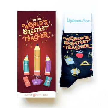 Card and sock set which reads "To the worlds greatest teacher" Has pencils, apples, books, eraser, and globe print.
