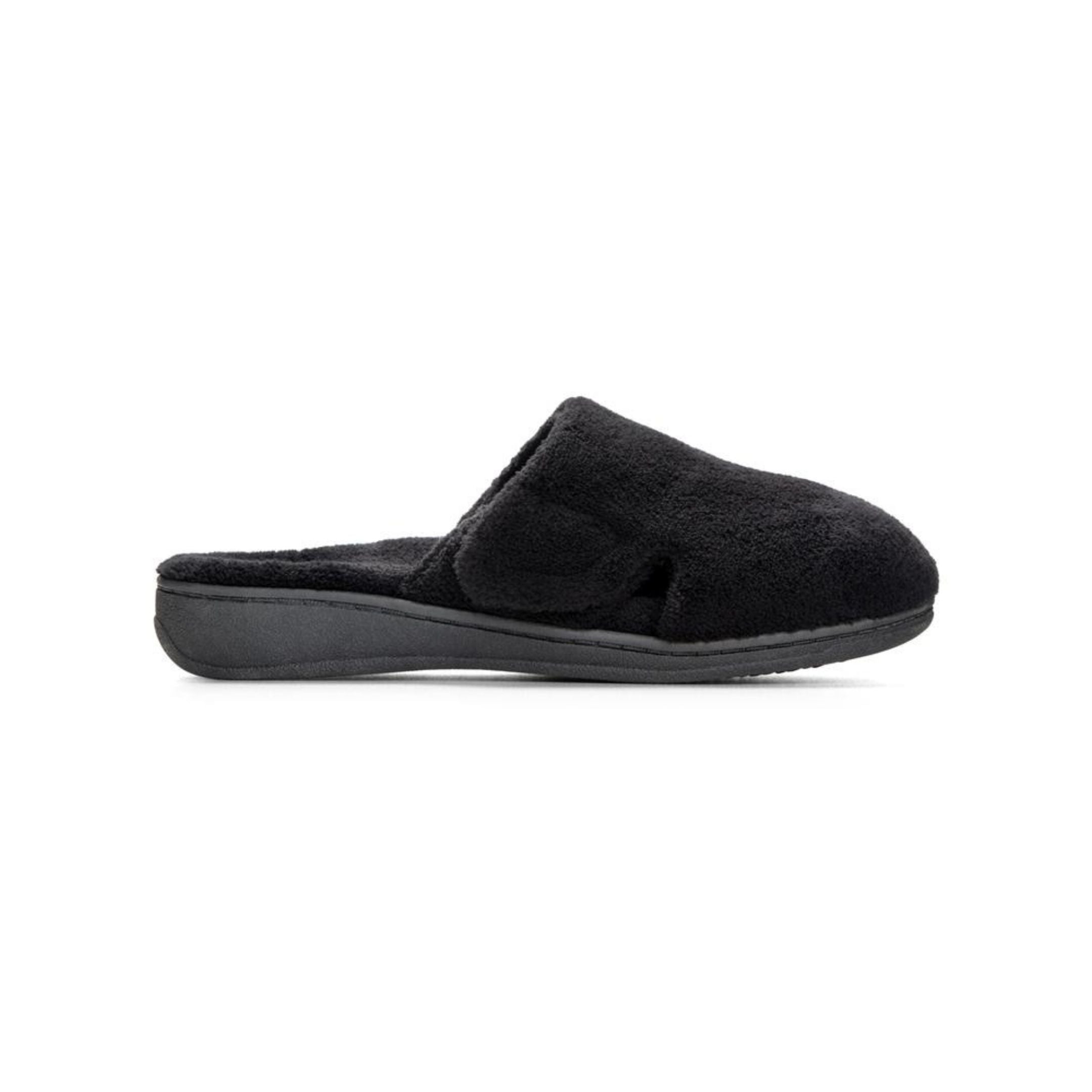 Side view of black fuzzy slip on slipper with black outsole.