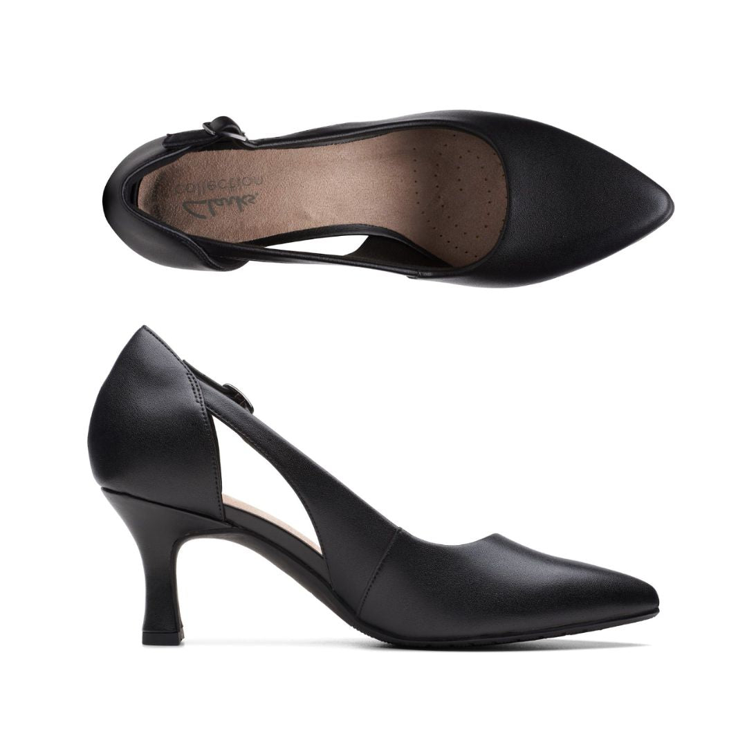 Top and side view of black leather pointed to pump with low kitten heel and adjustable side strap. Clarks logo is on heel of insole.