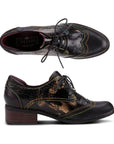 Top and side view of L'Artiste's black snake print lace-up shoe with stacked heel.