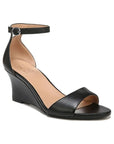 Black leather wedge with ankle strap that has a silver buckle.