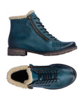 Teal ankle boot with lace and zipper closure. Boot has off white faux fur collar and brown outsole.